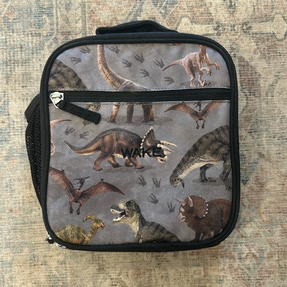 Potterybarn lunch box with name “Wake” on the front